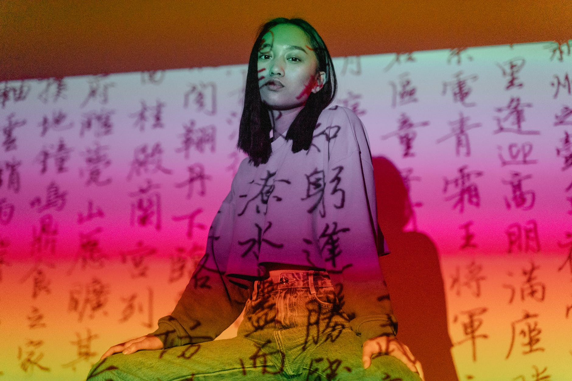 chinese characters overlaying a woman in purple long sleeves